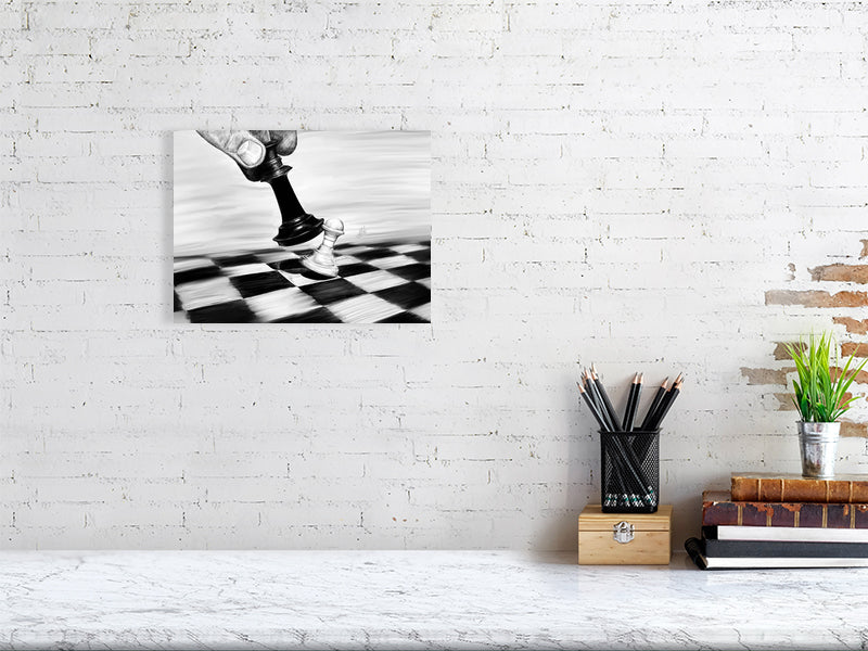 A medium size unframed pencil drawing of a chess piece moving on a checkered board to knock another piece over, hanging on a white brick wall over a desk.