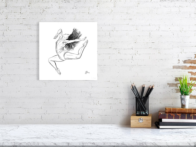 A medium sized square unframed ink drawing of a ballet dancer in mid-leap, signed by Sophie Hall and hanging on a white brick wall over a marble desk.