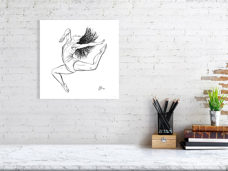 A large unframed ink drawing of a ballet dancer in mid-leap, signed by Sophie Hall and hanging on a white brick wall over a marble desk.