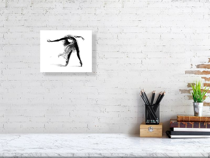 Small unframed print of a pencil drawing of a ballet dancer mid pose, by Sophie Hall. Print hangs on a white brick wall.