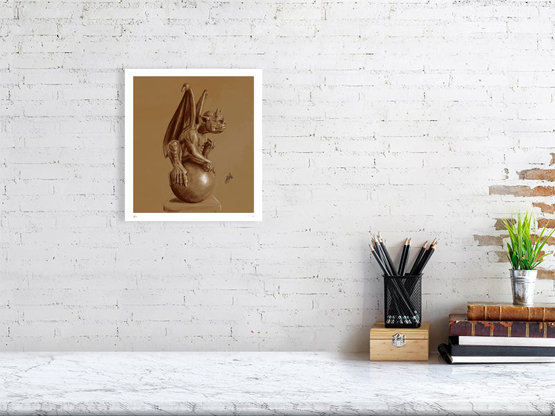 A medium unframed pencil drawing of a winged gargoyle creature sitting on a ball, rendered in brown pencil and chalk on a textured sienna paper and hanging on a white brick wall over a desk.