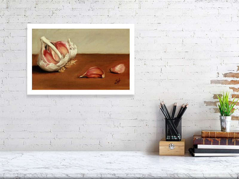 A large unframed print of a traditional still life oil painting featuring garlic bulbs and cloves on a wooden surface, signed by the artist Sophie Hall and hanging on a white wall over a marble desk.