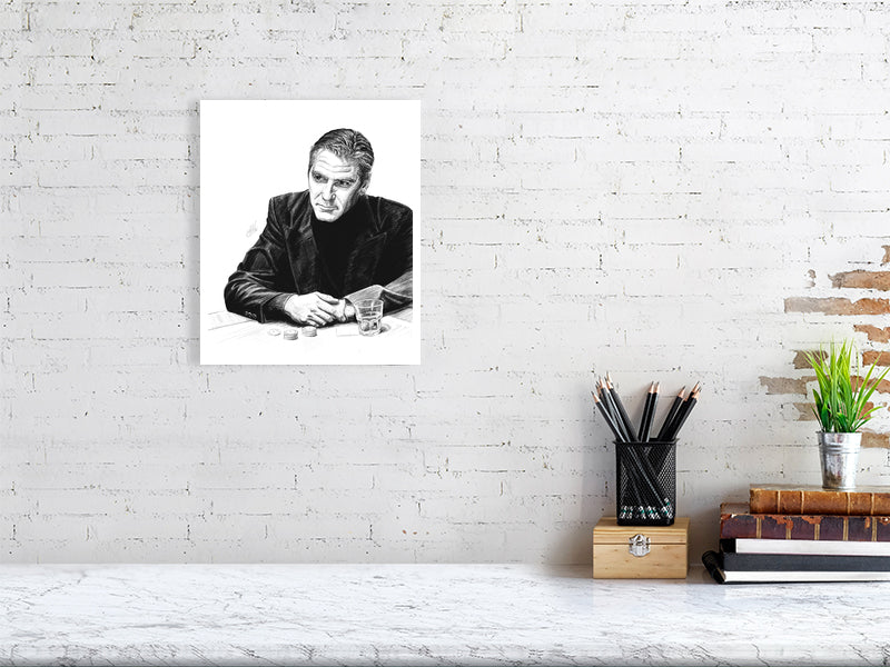 A medium size  unframed pencil portrait of George Clooney as Danny Ocean from Ocean's Eleven, drawn in black and white, hanging on a white brick wall over a desk.
