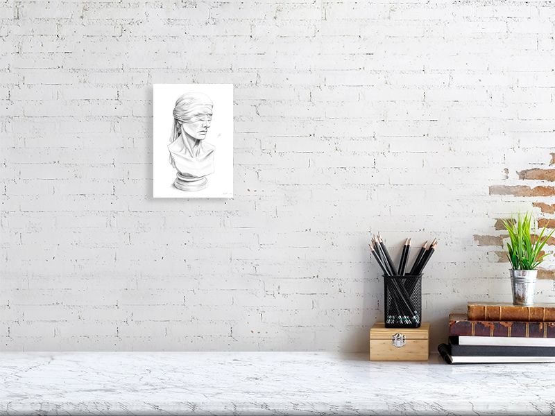A small unframed pencil drawing of a blindfolded justice statue, hanging on a white brick wall over a marble desk.