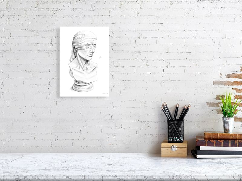 A medium size unframed pencil drawing of a blindfolded justice statue, hanging on a white brick wall over a marble desk.