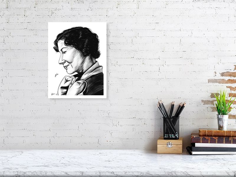 A large, unframed ink drawing of a woman with her head slightly tilted, looking off to the side, hanging on a white brick wall above a desk.