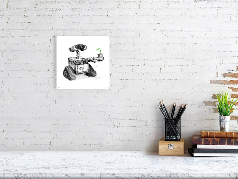 A medium size unframed pencil drawing of the iconic character Wall-E holding a small plant growing out of a boot, hanging on a white brick wall above a desk.