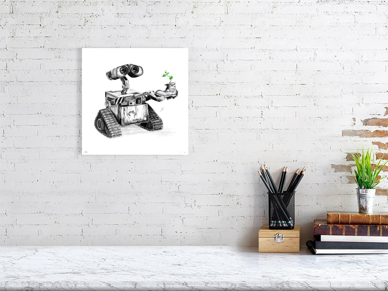 A large unframed pencil drawing of the iconic character Wall-E holding a small plant growing out of a boot, hanging on a white brick wall above a desk.