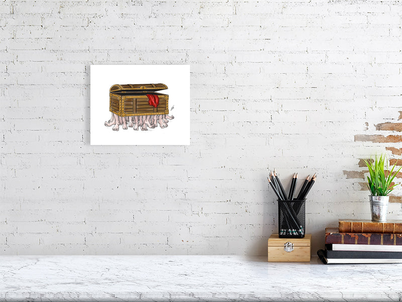 A small unframed ink illustration of the Luggage from Terry Pratchett's Discworld, hanging on a white brick wall over a marble desk.