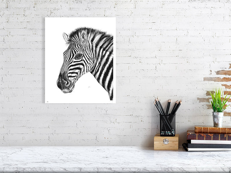 A large unframed pencil drawing of a zebra, hanging on an white brick wall over a marble desk. Signed and numbered by the artist.